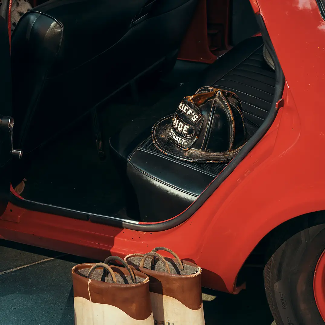 Vintage fireman's boots beside vintage fire engine
